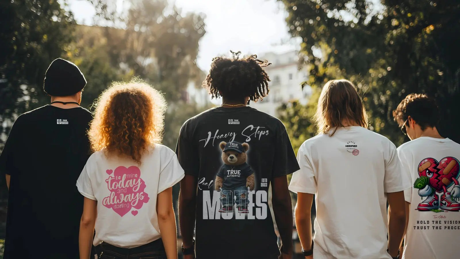 Five people walking outdoors, wearing t-shirts with various designs.