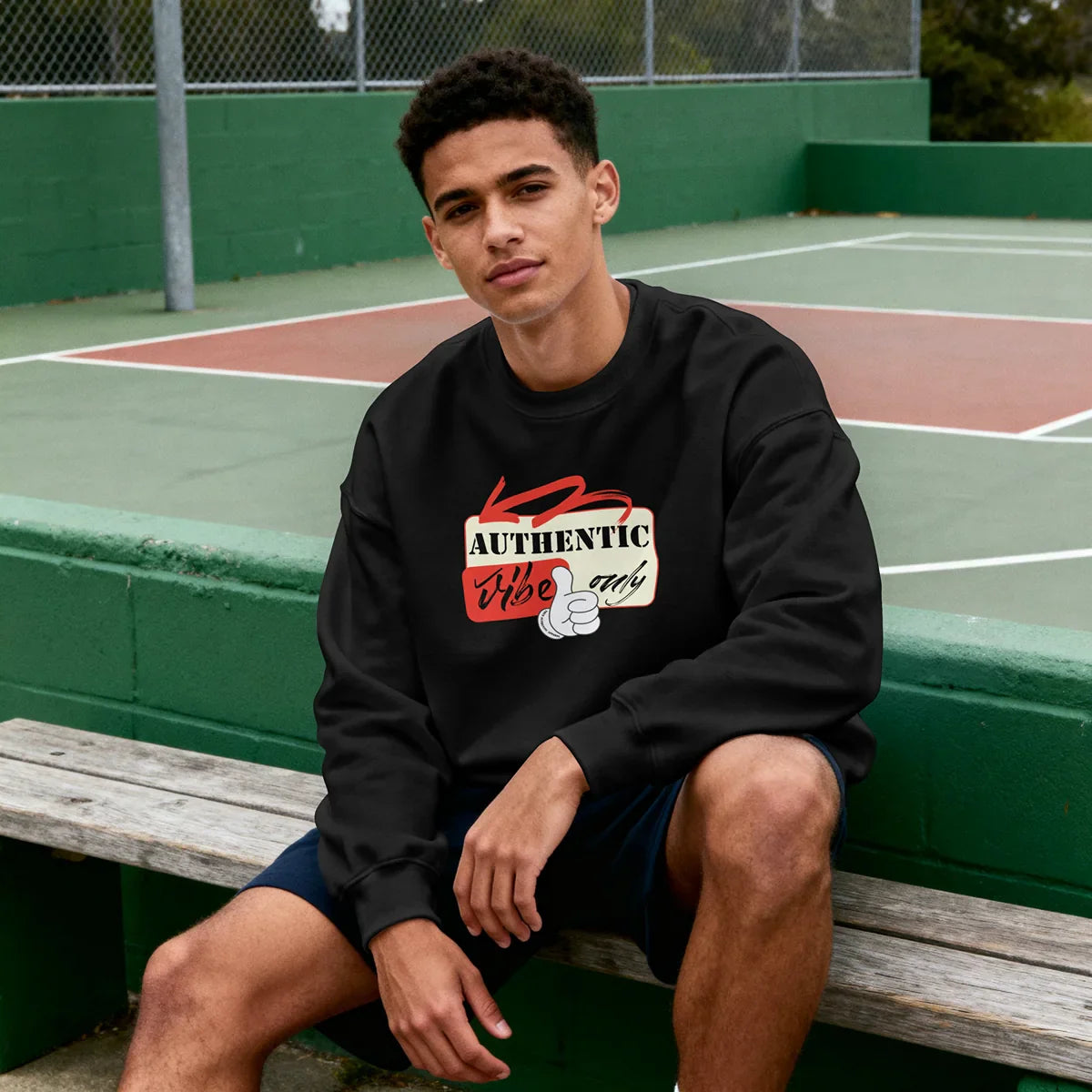 Male artist wearing a True Authentic black heavyweight "Scanner" hoodie with white drawstrings in a minimalist studio setting.