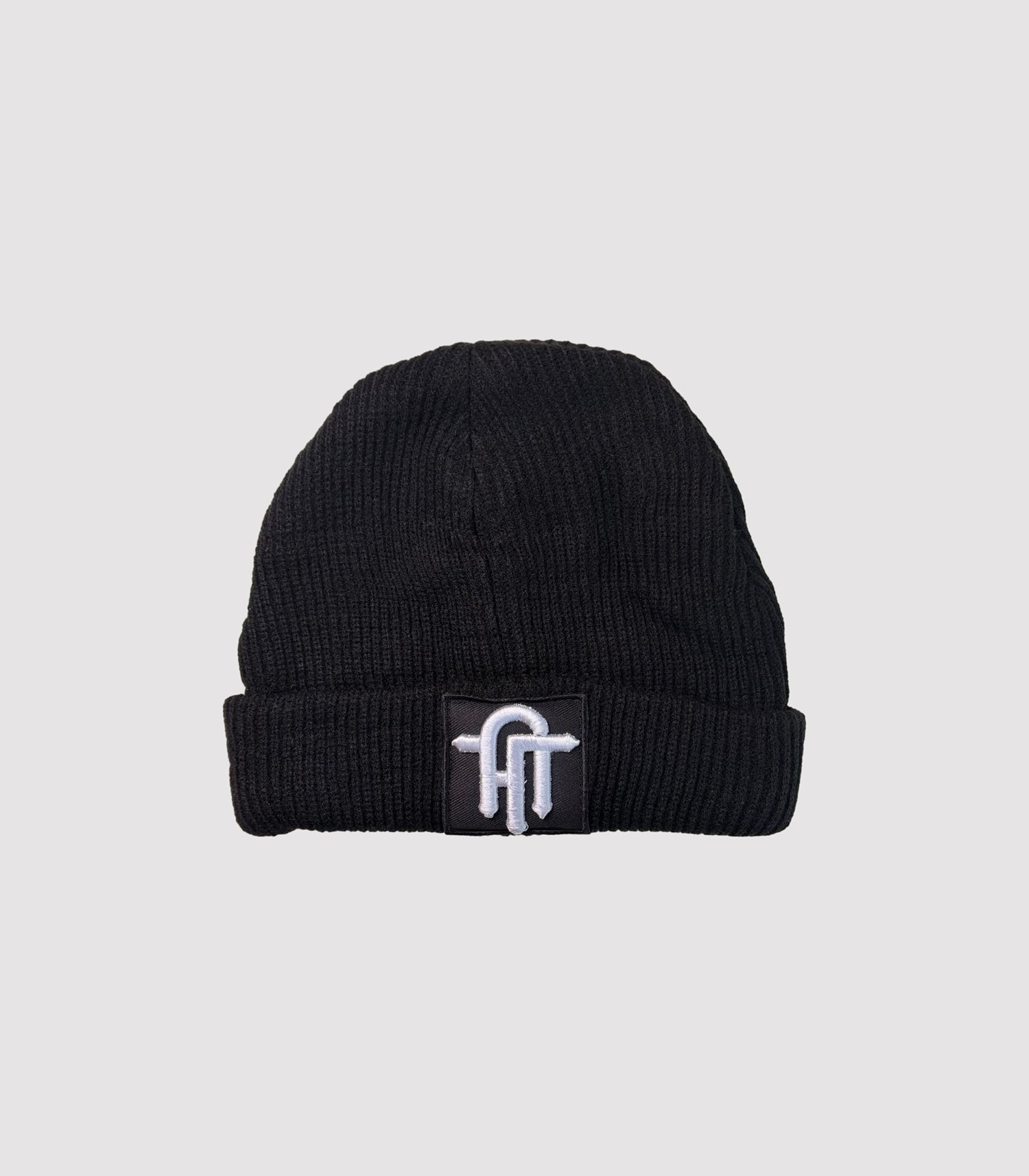 Black beanie with a logo on a light gray background