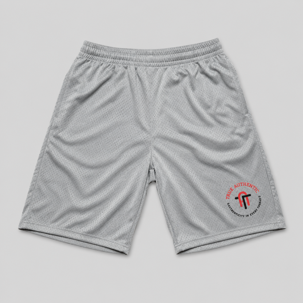 Light gray athletic mesh shorts with an elastic waistband and a circular red and black logo on the lower left leg, displayed flat against a light gray background.