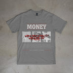 Gray t-shirt with graphic design and text on a concrete floor