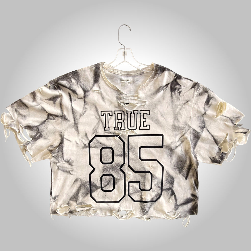 Tie-dye shirt with 'TRUE 85' text on a gray background