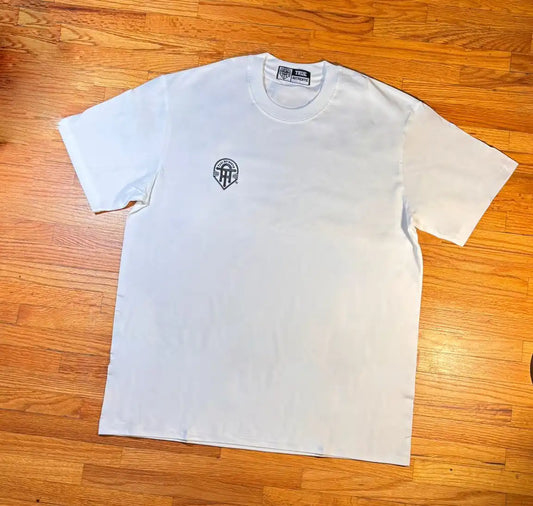 White t-shirt with a black logo on a wooden surface