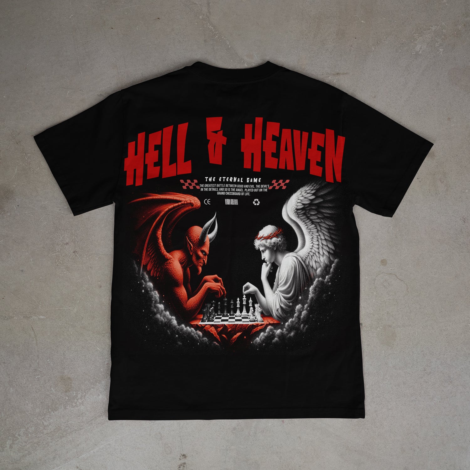 Black t-shirt with 'Hell & Heaven' design featuring a devil and angel playing chess on a gray background.