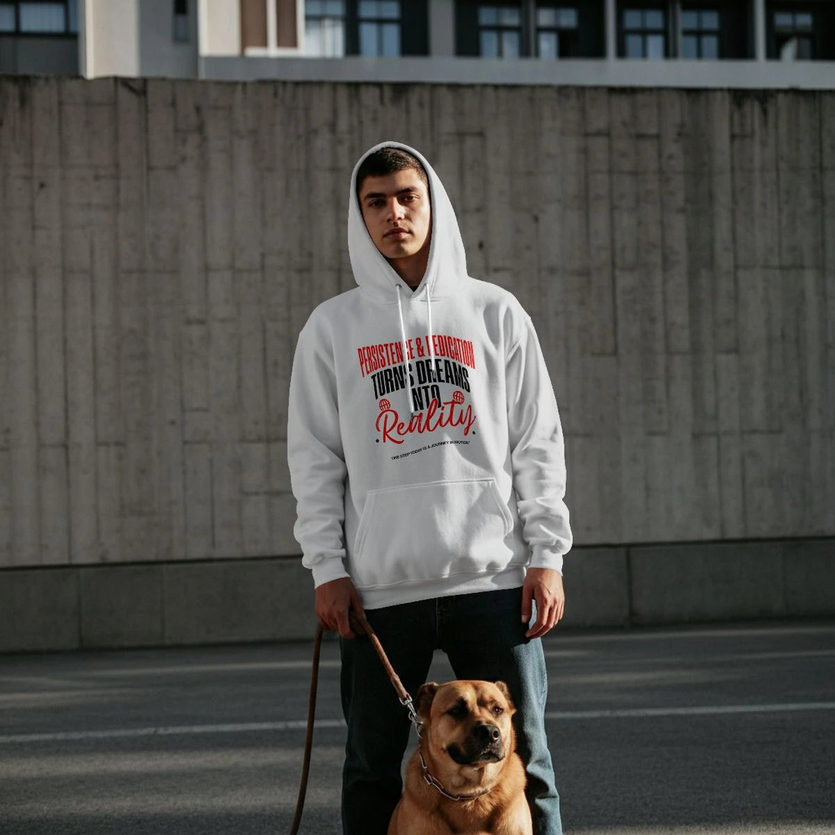 A man wearing the True Authentic Persistence and Dedication white hoodie in an urban setting with a dog.