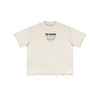 An off-white short-sleeve t-shirt with a raw, frayed hem and a small black text graphic on the chest reading 'TRUE AUTHENTIC'.