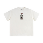 An off-white short-sleeve crewneck t-shirt featuring a small graphic print on the center chest depicting a badge with the text 'TRUE LOVE' and 'LOVE NEVER DIES'.