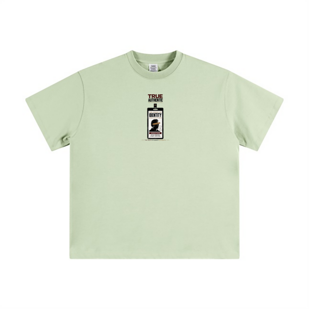 A light sage green short-sleeve t-shirt with a small graphic print on the center chest depicting a liquor bottle labeled 'TRUE LOVE' and 'BOSTON'.