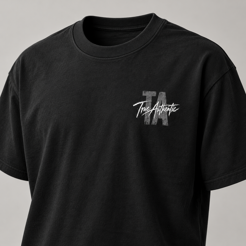 TRUE AUTHENTIC authentic script black cotton graphic tee — small left chest logo, close-up