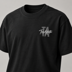 TRUE AUTHENTIC authentic script black cotton graphic tee — small left chest logo, close-up