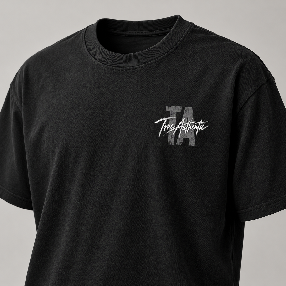 TRUE AUTHENTIC authentic script black cotton graphic tee — small left chest logo, close-up