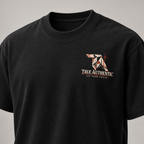 TRUE AUTHENTIC cut from truth black cotton graphic tee — small left chest logo, close-up