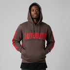 Person wearing a brown hoodie with red accents and text on a gray background