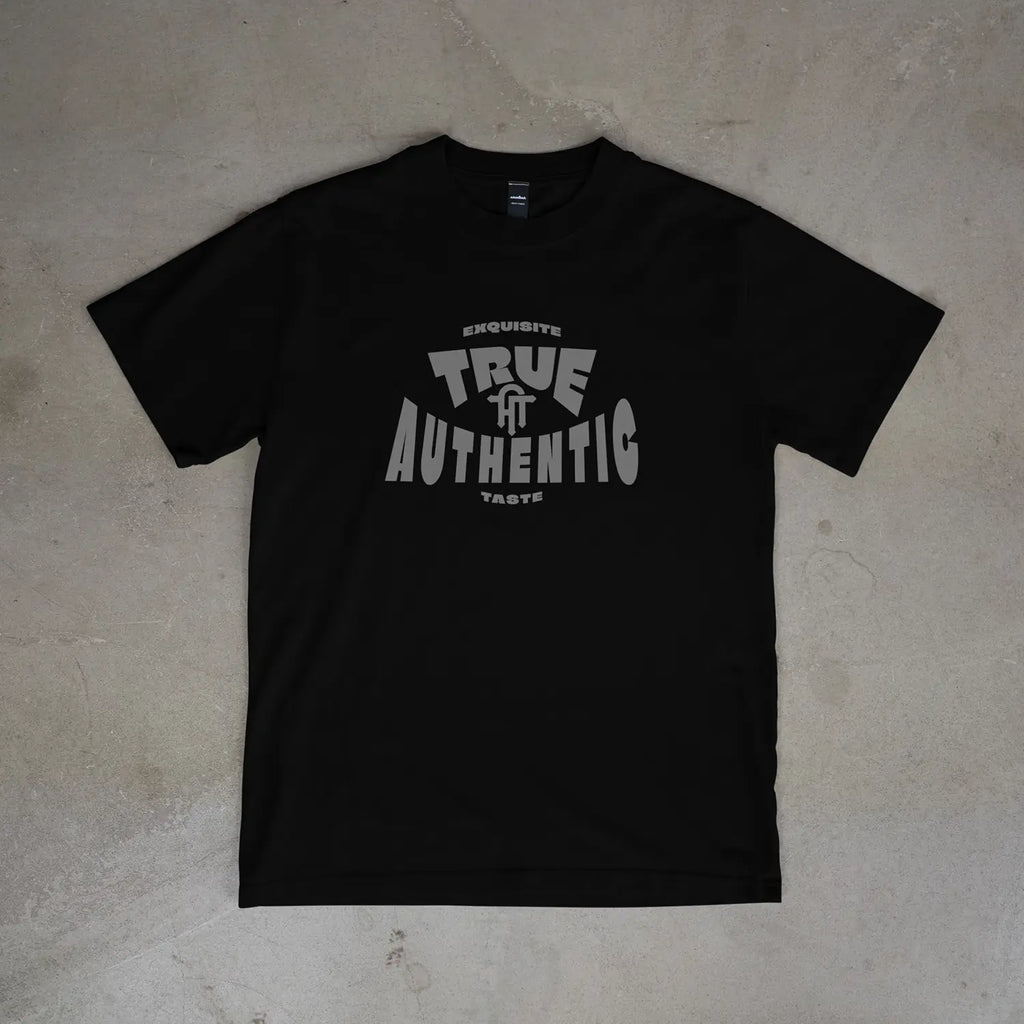 Black t-shirt with 'True Authentic' text on a beige surface