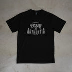 Black t-shirt with 'True Authentic' text on a beige surface