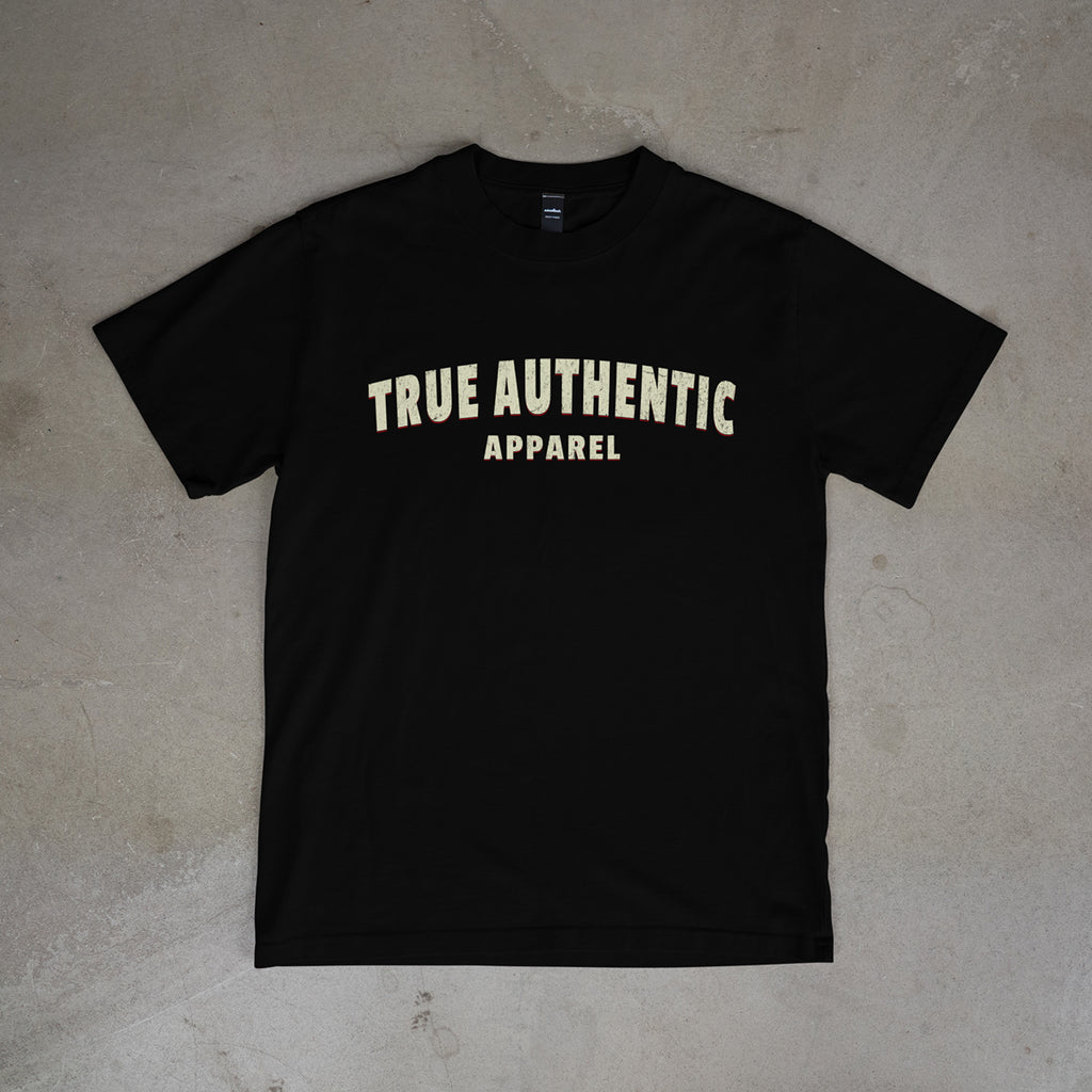 Black t-shirt with 'True Authentic Apparel' text on a concrete floor