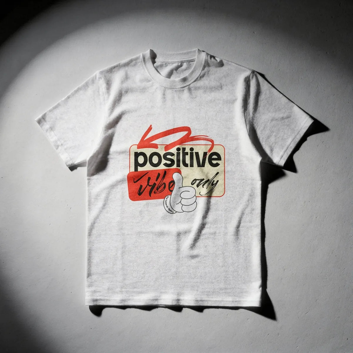 White t-shirt with a graphic design on a gray background