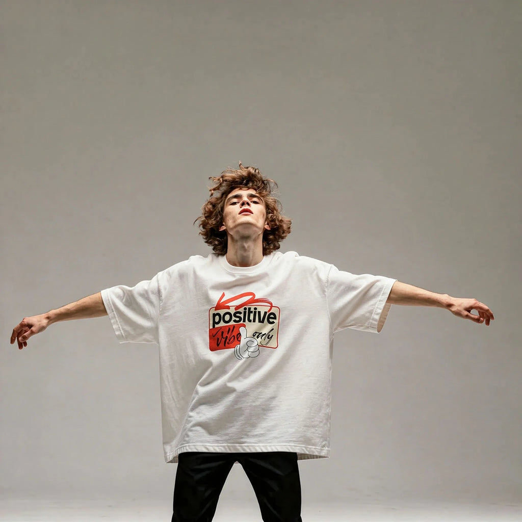 Person wearing a white t-shirt with a red and black graphic design on a gray background