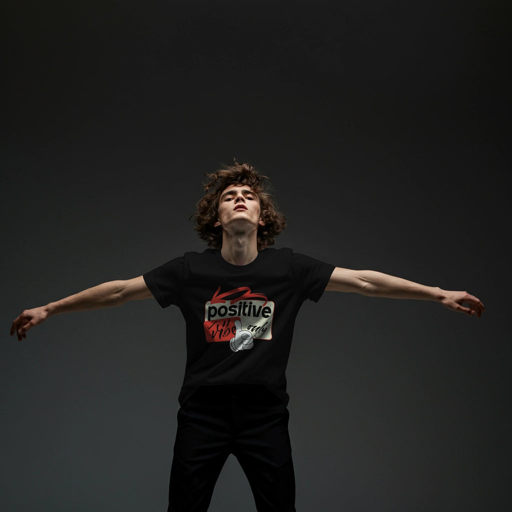 Person wearing a black t-shirt with a graphic design on a dark background