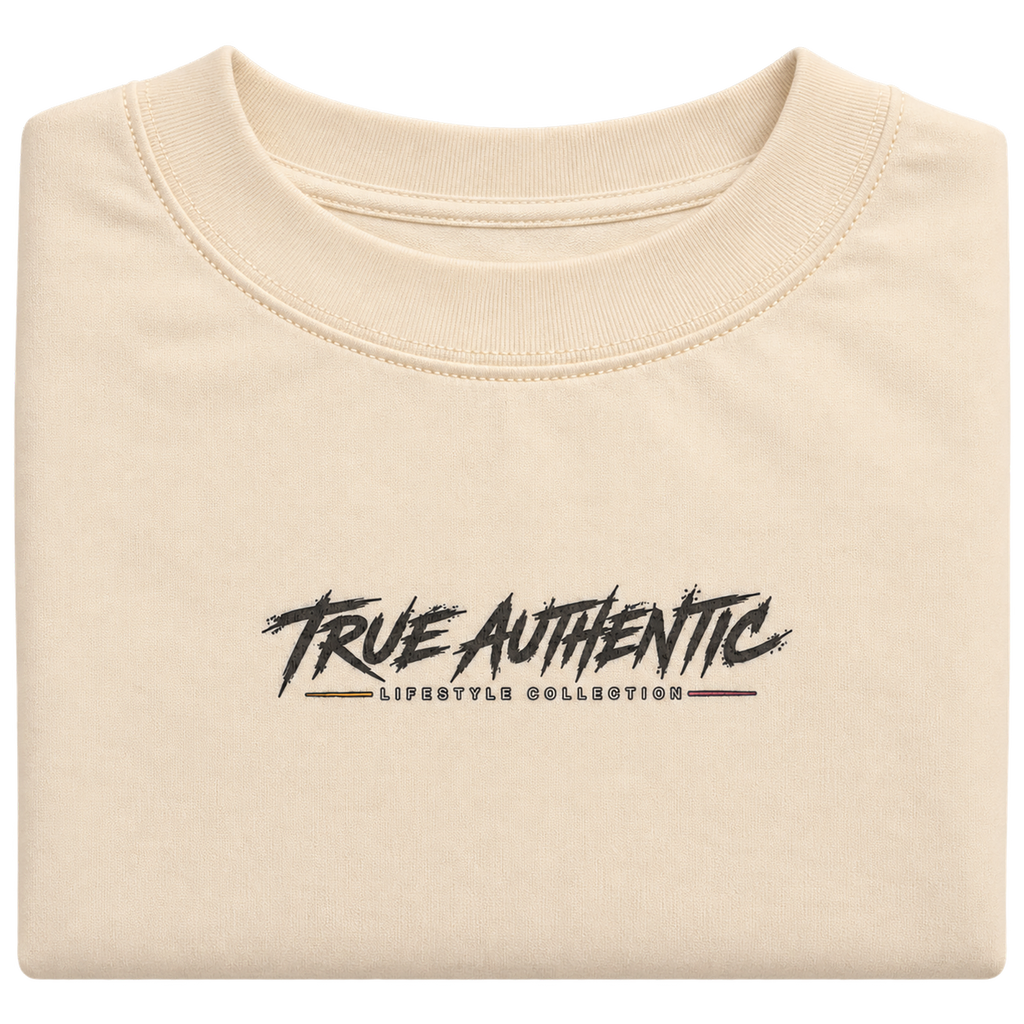 Close-up of True Authentic Lifestyle Collection logo on cream heavyweight cotton T-shirt