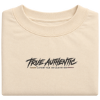Close-up of True Authentic Lifestyle Collection logo on cream heavyweight cotton T-shirt