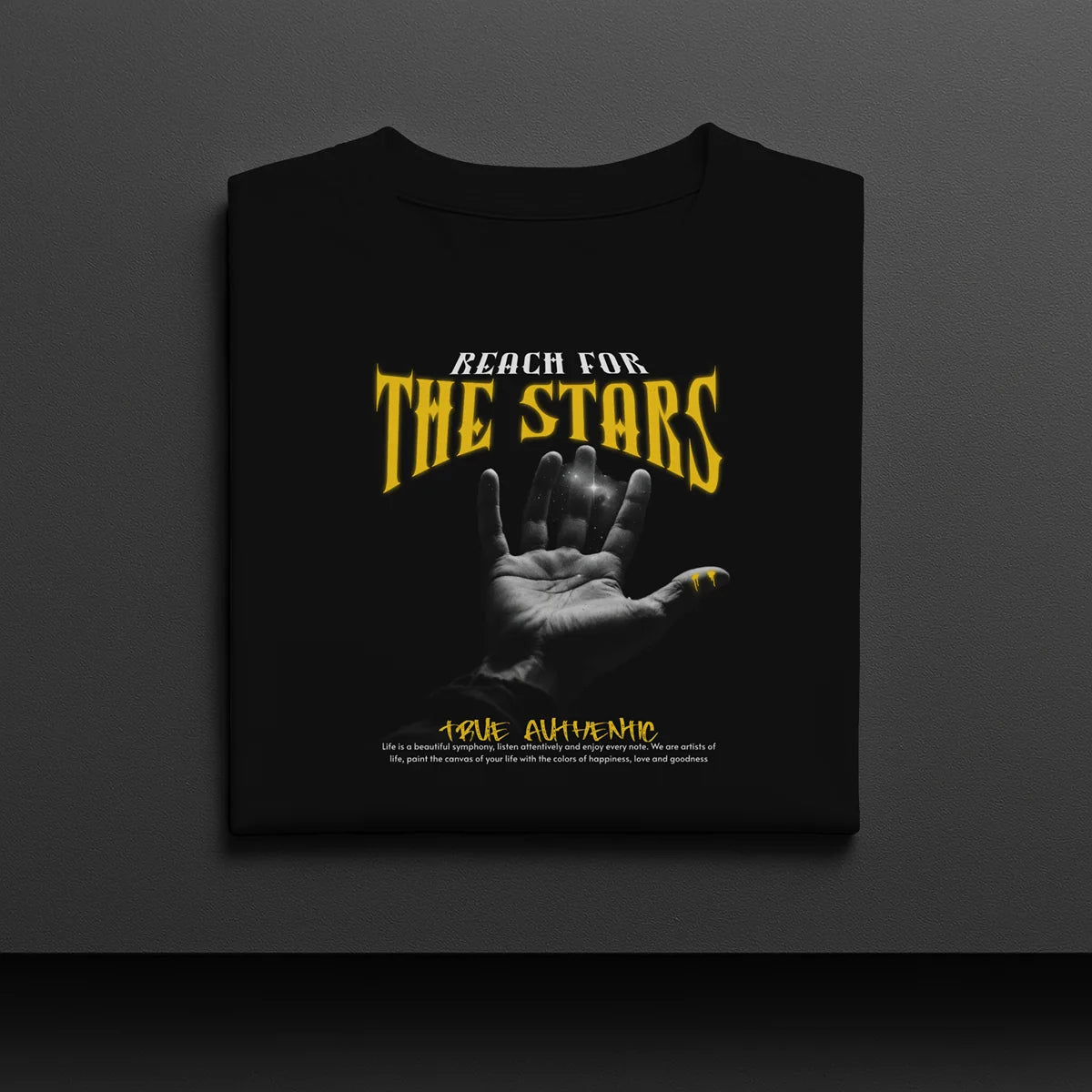 Black t-shirt with 'Reach for the Stars' text and hand graphic on a dark background