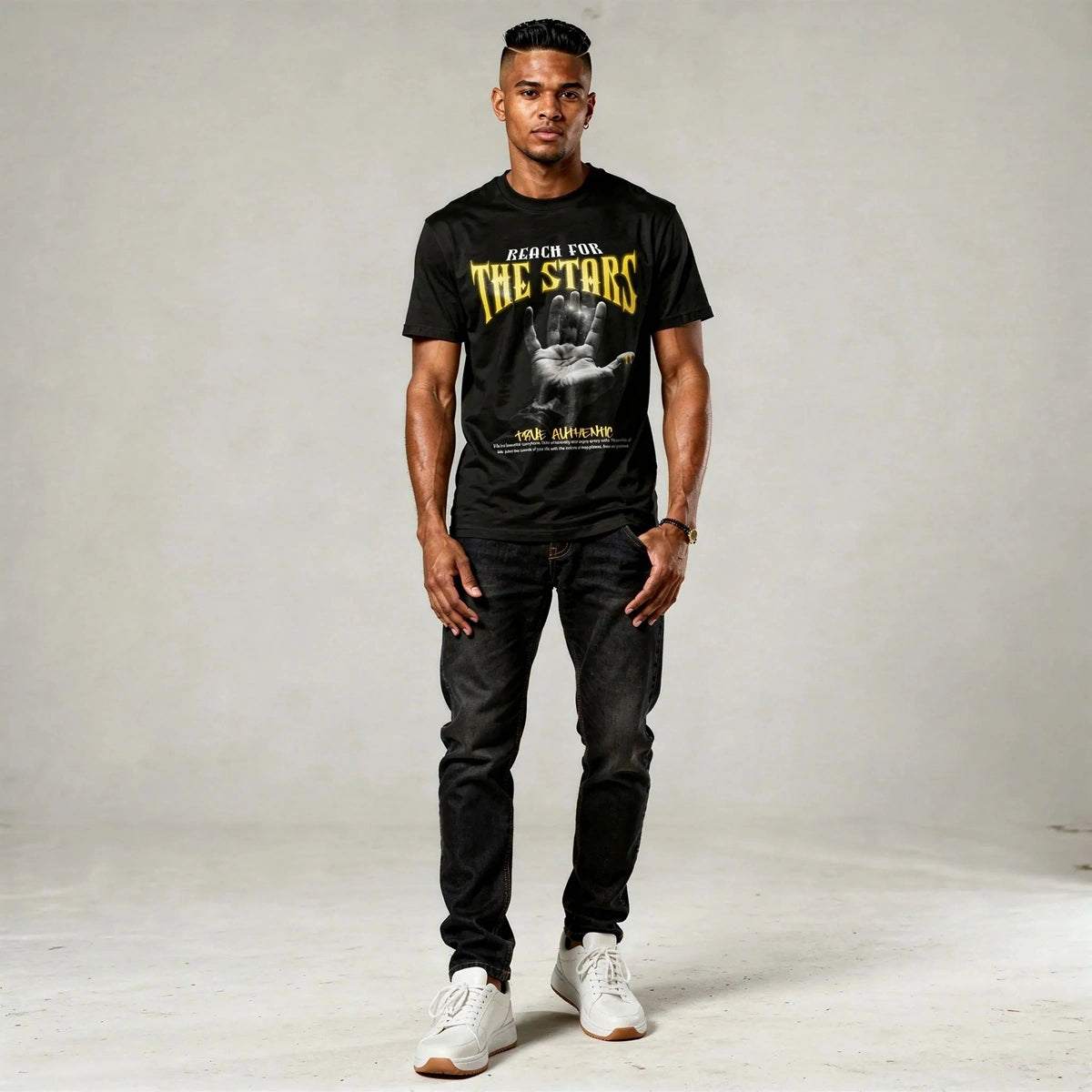 Man wearing a black t-shirt with graphic design and text, standing against a plain background