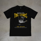 Black t-shirt with 'Reach for the Stars' graphic on a textured surface