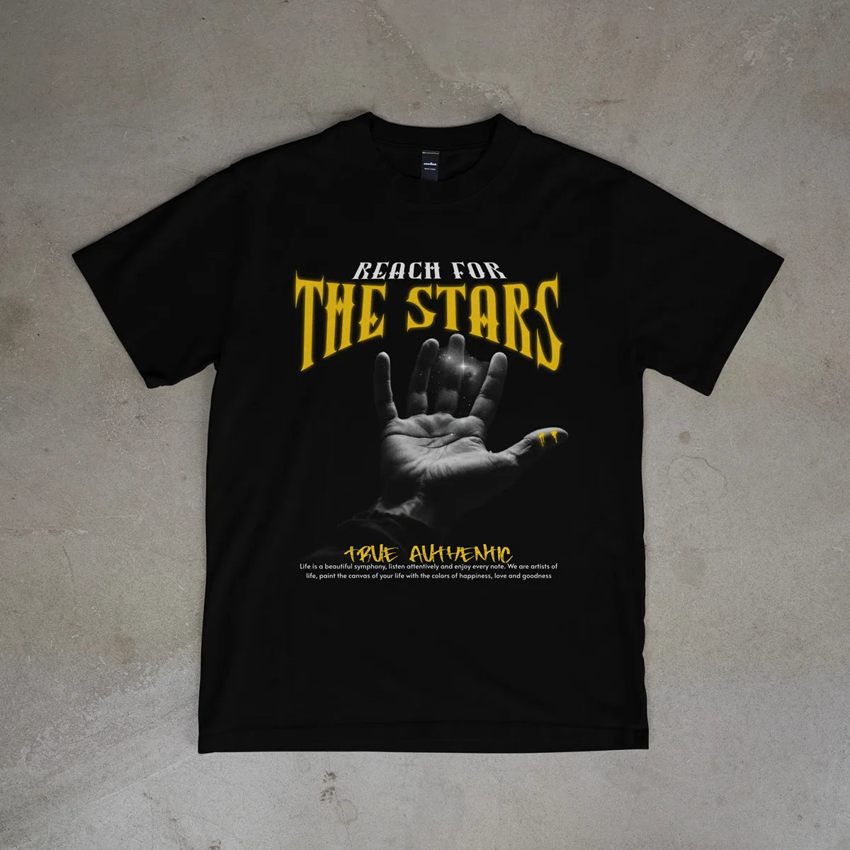 Black t-shirt with 'Reach for the Stars' graphic on a textured surface