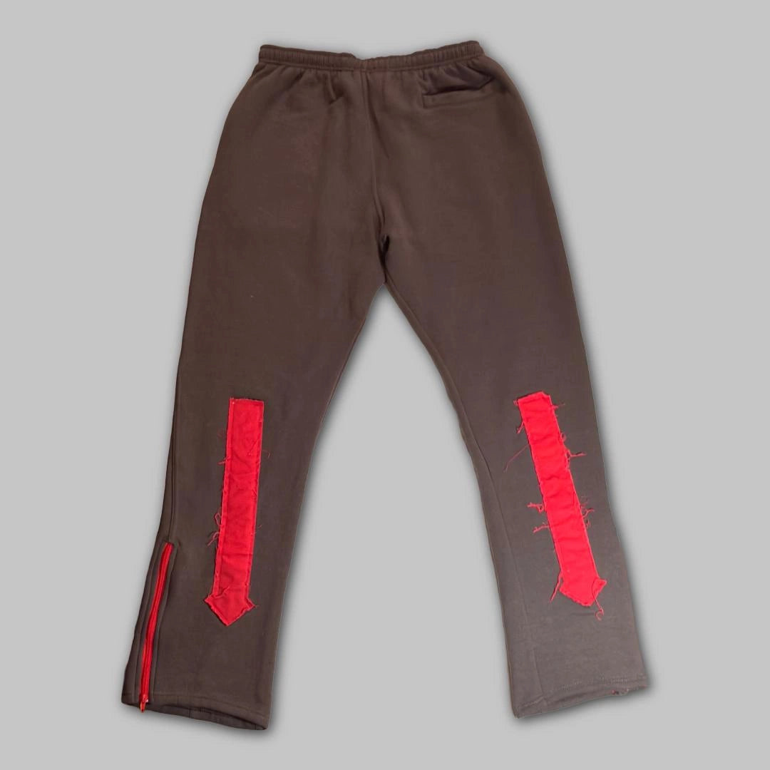 Brown pants with red accents on a gray background