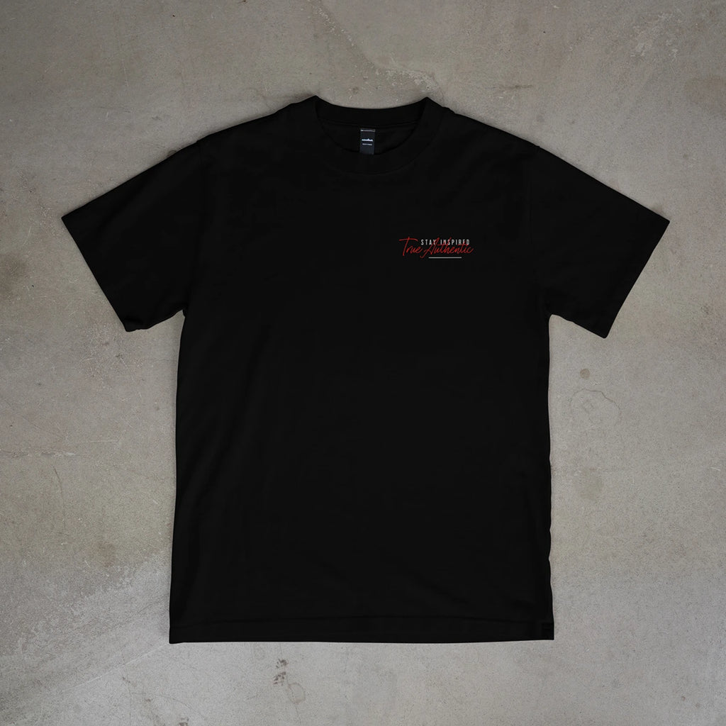 Black t-shirt with a logo on a beige surface