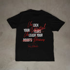 Black t-shirt with motivational quote on a beige surface