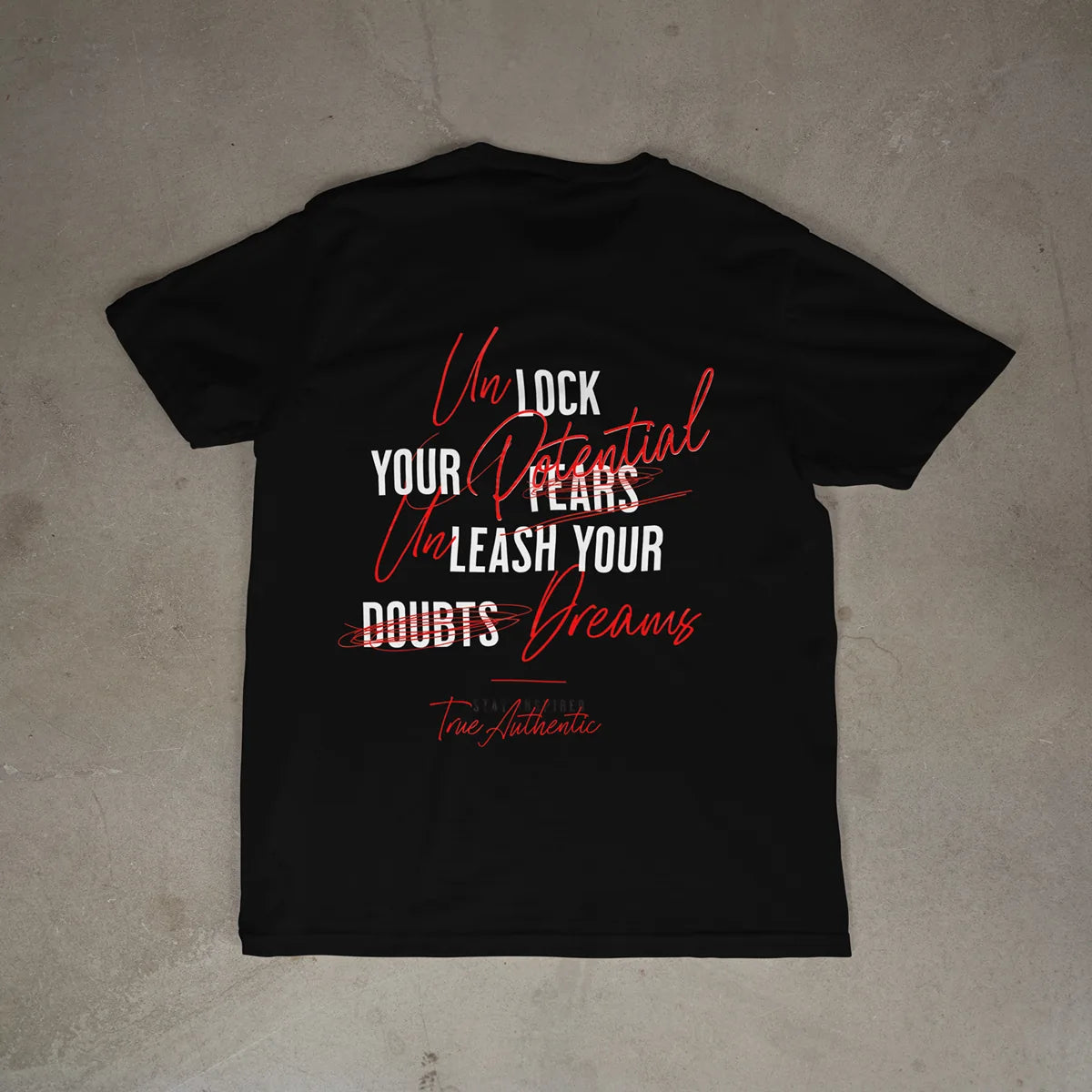 Black t-shirt with motivational quote on a beige surface