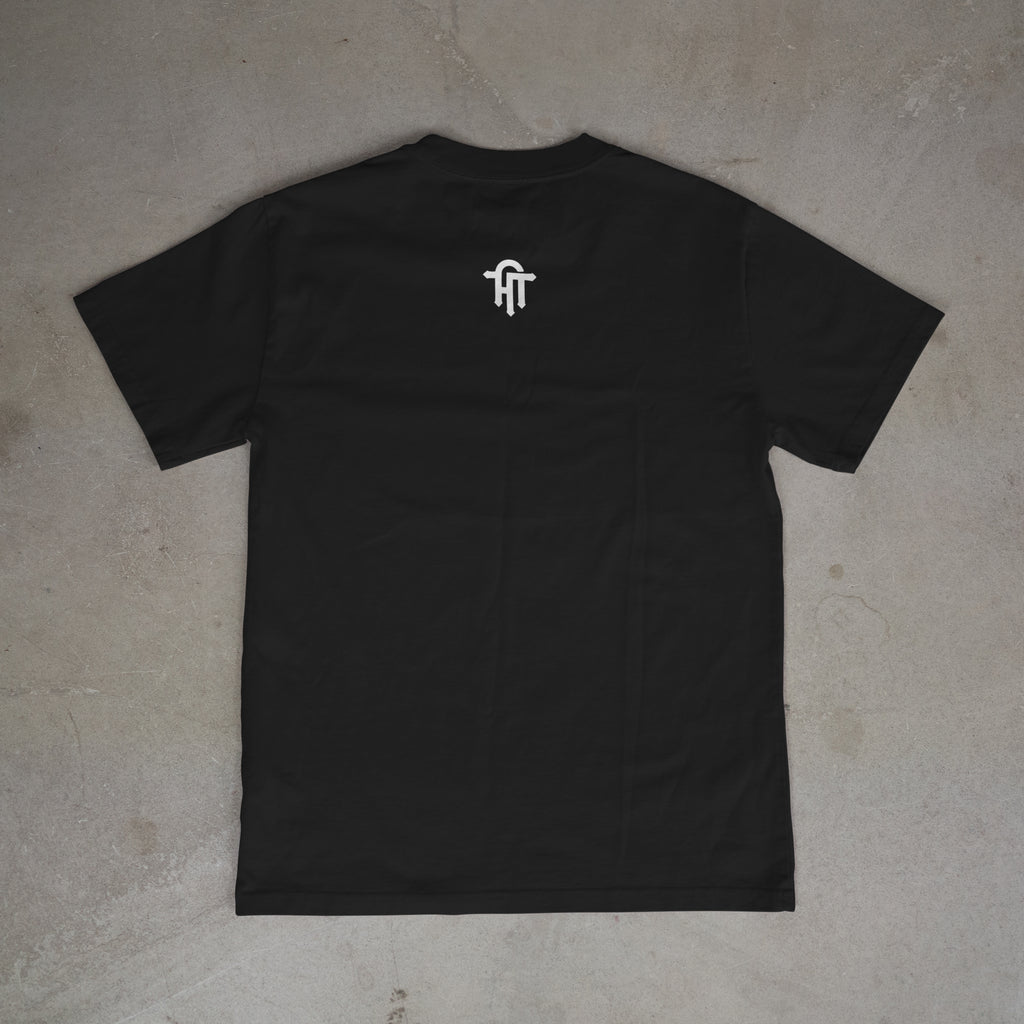 Black t-shirt with a white logo on the chest, laid flat on a gray surface.
